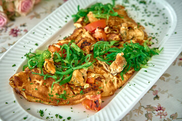 Deliciously Savory Omelette Garnished with Fresh Herbs and Vegetables, Perfectly Cooked for a Wholesome Meal Experience