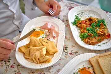 A Delicious Breakfast Spread Featuring Fluffy Crepes, Savory Omelette, Crispy Toast, and Fresh Ingredients for a Perfect Morning Meal Experience