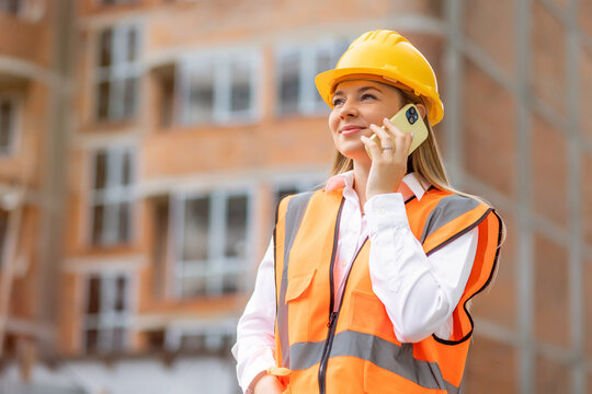 Female construction worker on the phone at a construction site
