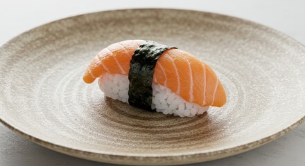 Fresh salmon sushi nigiri on a decorative ceramic plate, ready to be enjoyed