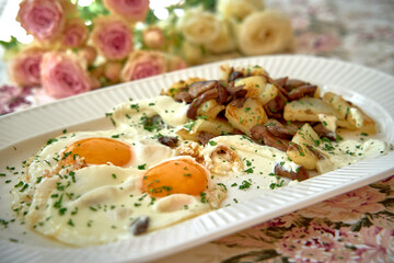 Deliciously Cooked Eggs Served with Golden Brown Potatoes Garnished with Fresh Herbs and Accompanied by a Blooming Floral Arrangement