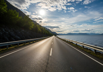 Fototapeta premium Beautiful landscape view of a highway bordered by green forest and an expansive, sparkling lake.