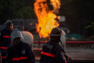 Firefighter Rescue team training fire fighting extinguisher. Teamwork Firefighter fighting with...