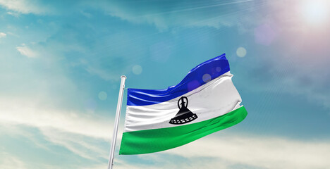 Lesotho national flag waving with beautiful sky.
