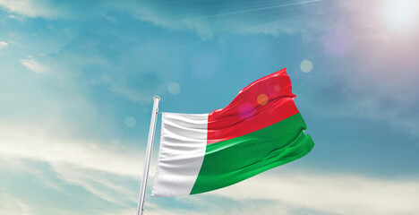 Madagascar national flag waving with beautiful sky.