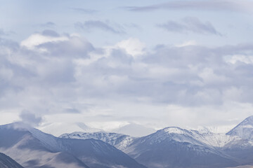 Minimalistic landscape panorama with mountains in the highlands of Tien Shan in Pamir, in the morning cloudy weather, landscape for background