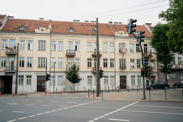 Urban street with historic residential buildings and traffic lights at empty intersection in kaunas...