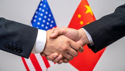 Handshake representing collaboration between China and the USA, with flags in the background. This handshake symbolizes international cooperation
