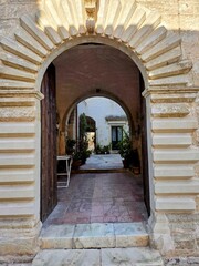 The entrance arch of an old house in the medieval quarter of Galatone, an old town in Puglia, Italy.