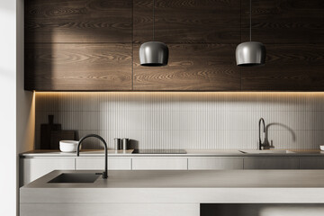 Modern minimalist kitchen interior with light concrete island, wood cabinets, and pendant lighting under warm strip light in neutral tones. 3D Rendering