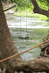 A swing hangs on the surface of the water.
