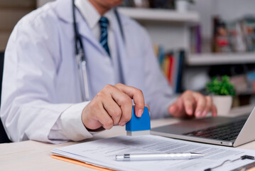 doctor is stamping an important medical document, indicating the confirmation of information, approval of treatment, issuance of a certificate, professional and legal work.