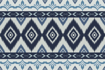 Seamless indigo ikat patterns in ethnic tribal style, featuring geometric diamond shapes and woven texture in blue tones.