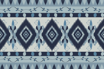 Seamless indigo ikat patterns in ethnic tribal style, featuring geometric diamond shapes and woven texture in blue tones.