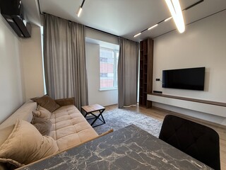Modern Living and Dining Area with Contemporary Lighting