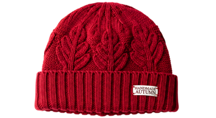 A red knitted beanie with a handmade autumn label, isolated on transparent background
