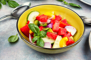 Bowl of salad with watermelon, cucumber.