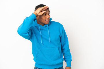 Fototapeta premium Young latin man isolated on white background with surprise expression while looking side