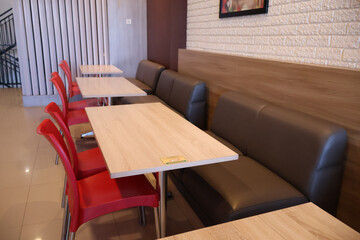 Interior view of fast food restoran, empty chair and table.