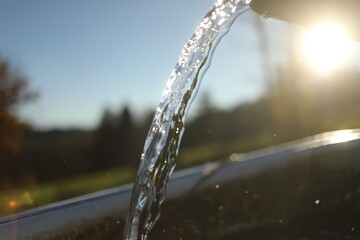 Stream of water is flowing from a faucet