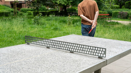 Table tennis in park. Ping pong summer sport outside, people play pingpong, table tennis game