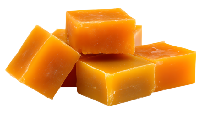 Pile of natural yellow beeswax blocks displayed isolated on white or transparent png, showing the solid form of this ingredient used in cosmetics and crafts.