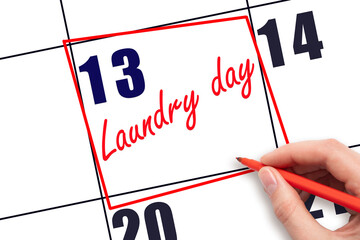 13th day of the month.  Hand writing Laundry day reminder and drawing red frame on calendar with...