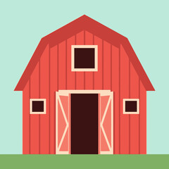 Red barn with open doors on green grass against a light blue sky.