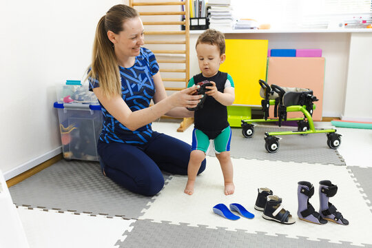 Physiotherapist selects right orthopedic solution for treatment of child's foot deformity in rehabilitation center patient