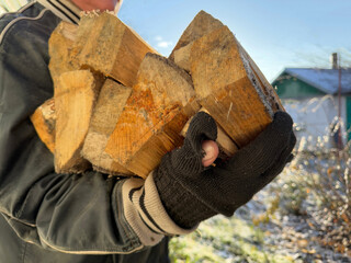 Poor man carrying firewood in winter.