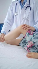Doctor and kid patient. Orthopedist examining girl's knee in medical clinic. Medicine and health...