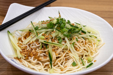 Chinese style cold noodles with cucumber slices and peanut