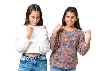 Friends girls over isolated chroma key background celebrating a victory in winner position