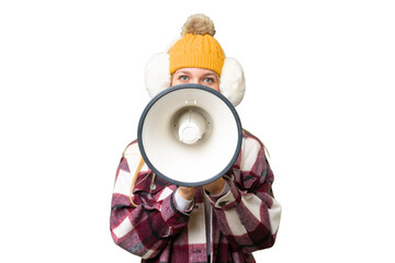Young pretty blonde woman wearing winter muffs over isolated chroma key background shouting through a megaphone