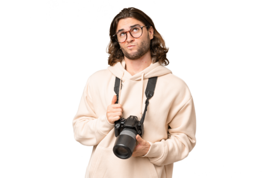 Young photographer man over isolated background looking up while smiling - Powered by Adobe