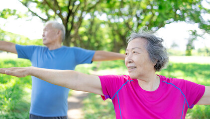Happy asian senior couple exercising in the park.