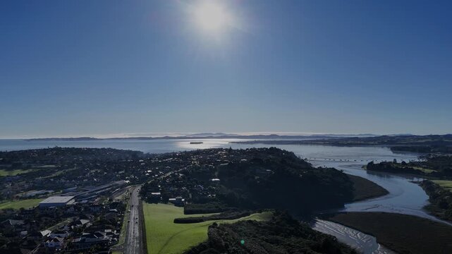 Aerial shot of vast blue ocean under the sunny afternoon sky in Auckland, New Zealand.