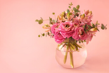 Summer blossoming delicate ranunculus on blooming flowers festive background, pastel and soft pink bouquet floral card, selective focus