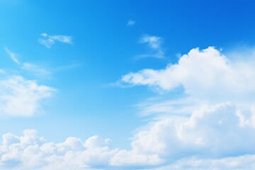 Obraz premium Beautiful white clouds are seen against a bright blue sky, creating a serene and uplifting atmosphere