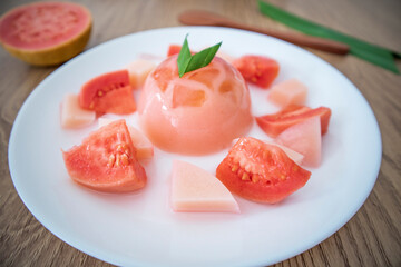 Pink guava jelly pudding on white background. Summer minimalism. Isometric flat lay