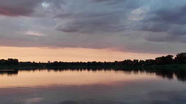 very beautiful sunset with water. summer evening landscape with reflection of clouds in water. setting sun on horizon. summer landscape with lake. reflection of trees in water. sunrise on river
