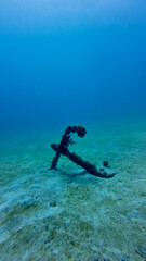 Lost anchor underwater. Old anchor on the sandy bottom of the sea underwater.