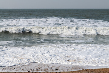 tranquil seascape with breaking waves on the beach in winter