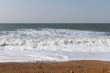 tranquil seascape with breaking waves on the beach in winter