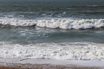 tranquil seascape with breaking waves on the beach in winter