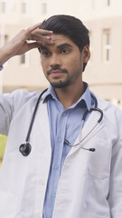 Vertical Photo of Indian Doctor Having Headache, Migraine