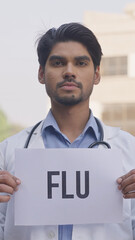 Vertical Photo of Indian Doctor Holding Flu Poster