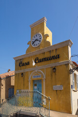 Town hall with yellow facade and clock tower, France, Corsica, Cargèse, 15 June 2025