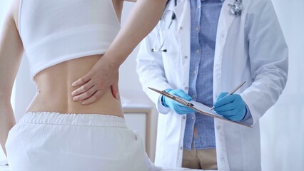 Doctor man wearing blue medical gloves is making notes on a clip