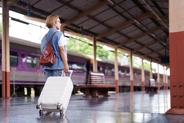 older asian woman travel train station suitcase journey independence adventure